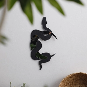 Artistic snake shaped mirror wall decor with black frame against a white textured background