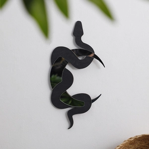 Detail of bohemian black snake wall hanging with integrated wood and mirror surfaces