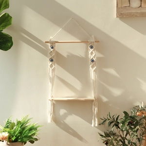 Bohemian handmade macrame wall shelf with evil eye beads and natural wood finish