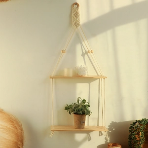 Macro detail of Bohemian double hanging wooden shelf with hand-woven cotton ropes and tassels
