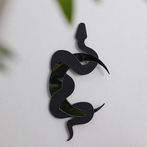 Detail of bohemian snake wooden mirror wall sticker on clean white background wall
