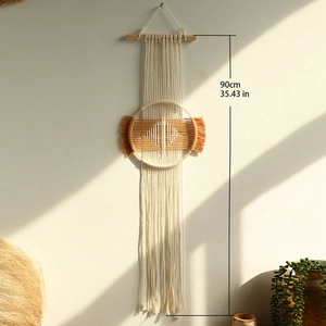 Bohemian handmade cotton wall tapestry with geometric patterns and long fringe hanging on wood