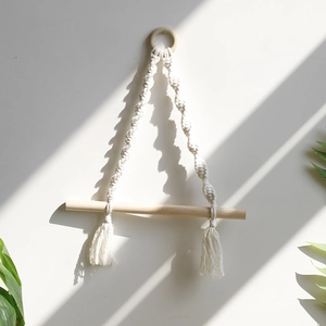 Detail of bohemian woven cotton tapestry with wood ring and tassel wall hanging decor