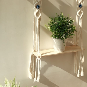 Bohemian handmade macrame wall shelf with evil eye beads and natural wood board