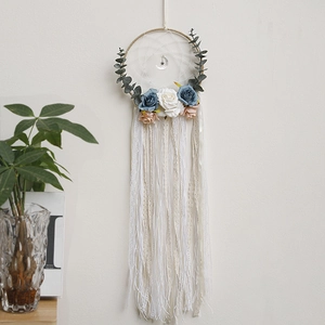 Detail of bohemian dream catcher with blue roses and silver moon charm pendant
