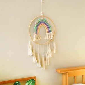 Close-up of handmade bohemian woven rainbow wall hanging with soft cotton fringe detail