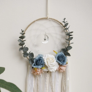 Detail of bohemian dream catcher with lace ribbons and floral vine decor