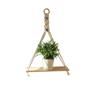 Bohemian handmade macrame plant hanger with evil eye beads and natural wooden shelf