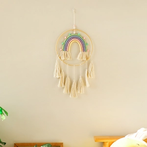 Detail of bohemian handmade rainbow wall hanging with soft macrame tassels and wooden ring