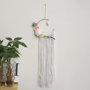 Detail of bohemian moon dream catcher with lace ribbons and silk rose flower accents