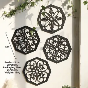 Detail of four black hexagonal mandala wall art pieces on a white textured background