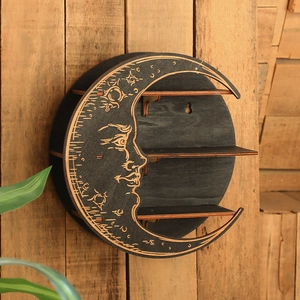 Macro detail of moon-shaped wooden wall shelf with carved face and tiered storage