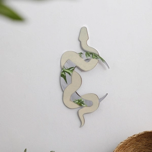 Detail showing creative 3D layered wooden mirror with artistic snake shape wall decor