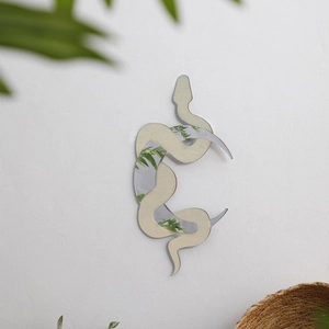 Detail of bohemian snake and moon wall mirror showing golden finish and 3D mirror texture