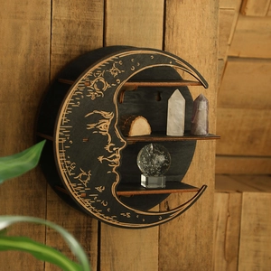 Detail of moon-shaped wooden wall shelf with mystical moon face carving and three small tiers