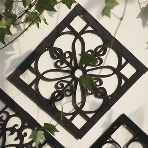 Modern black geometric wood wall art decor with intricate laser cut floral pattern