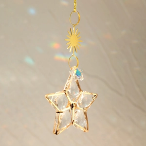 Golden metal star suncatcher with faceted crystals and rainbow reflections for home decor