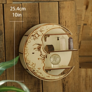 Detail showing carved moon face on a rustic wooden crescent shelf with crystal display
