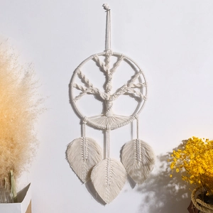 Detail of macrame tree of life wall hanging with handmade cotton leaf tassels decoration