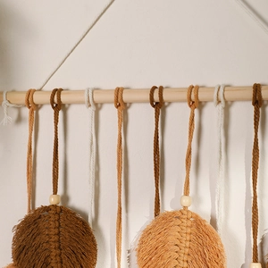 Detailed macro view of bohemian macrame feathers with cotton tassels and wooden beads