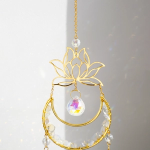 Detail of lotus moon suncatcher with white crystals and iridescent prism light reflection