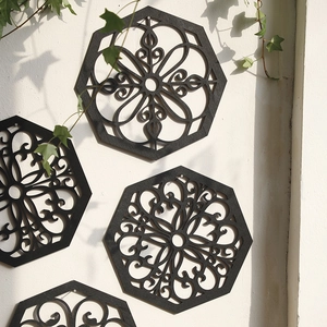Set of black geometric wood mandala wall art panels with intricate cutout flower patterns