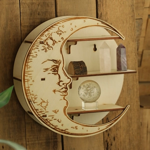 Detail of moon-shaped wooden wall shelf with triple tier display for crystals