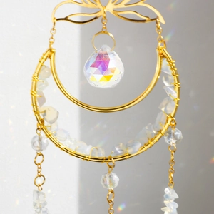Macro detail of moon lotus sun catcher with crystal prism and colorful light refraction