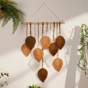 Detailed macro view of bohemian hand-woven cotton leaf tapestry with wooden rod and shadows
