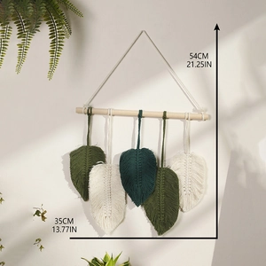 Handmade bohemian leaf wall hanging with green cotton woven leaves and wood rod