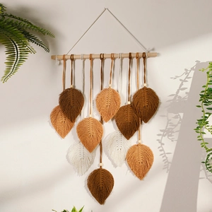 Close-up of Macrame wall hanging with handmade woven cotton leaves and fringes