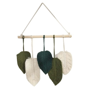 Nordic macramé wall hanging with five woven cotton leaves on a natural wood branch