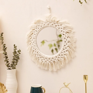 Detailed close-up of a bohemian wall mirror with handmade macrame cotton fringe and beads