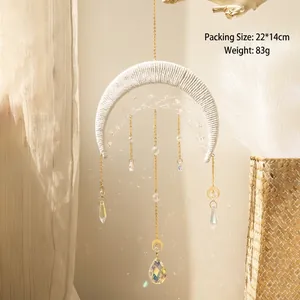 Macro detail of handmade bohemian moon dream catcher with crystal prisms and suncatcher beads