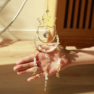 Detail of blue lotus moon suncatcher with opal stones and faceted crystal beads hanging