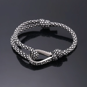 Adjustable black and white woven cord bracelet with polished silver horseshoe clasp