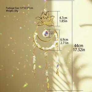 Close-up of golden lotus and moon suncatcher with crystal ball and hanging stones