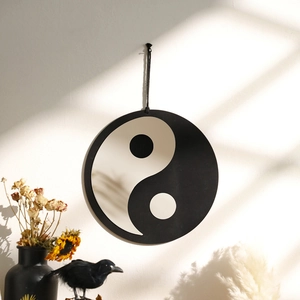 Detail of bohemian Tai Chi Yin Yang wall hanging with elegant black and white acrylic mirror