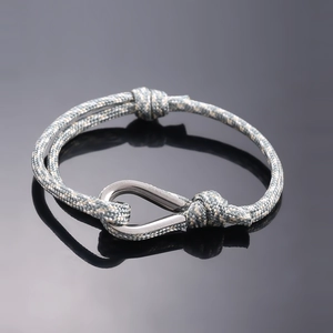 Braided grey and gold cord bracelet with silver U-shaped metal buckle and slide knots