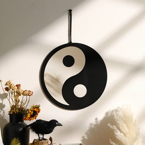 Close-up of Yin-Yang wall decor with shadow effects and minimalist dry flower background