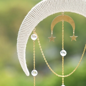 Detail of woven crescent moon suncatcher with metallic stars and faceted crystal beads