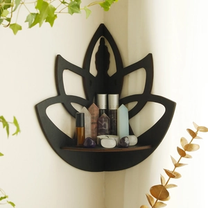 Close-up of black lotus wooden corner shelf with crystals and candles in home setting