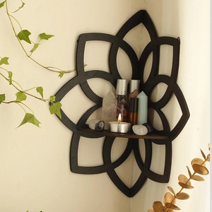 Detail of black lotus corner shelf with intricate laser-cut patterns for home decor