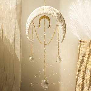 Boho moon wall hanging with white macrame, gold metal charms, and suncatcher crystals