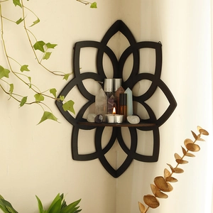 Detail of black lotus corner shelf showing intricate hollow wood mandala craftsmanship