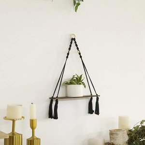 Bohemian black hand-woven macrame wall shelf with wood board and tassel for home decor