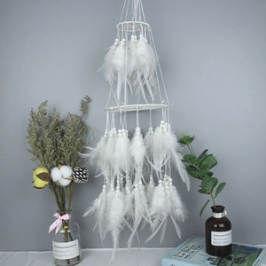 White bohemian dream catcher with layered rings and soft feathers for home wall decor