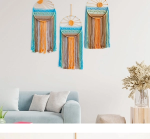 Detail of three-piece sunrise tapestry set with handmade cotton fringe on white wall
