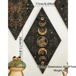 Detail view of rhombic black wood wall decor with golden moon and floral patterns