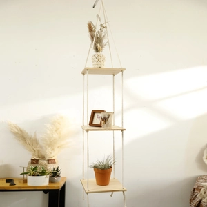 Detailed view of the three-tier bohemian hanging shelf with cotton rope and wood texture
